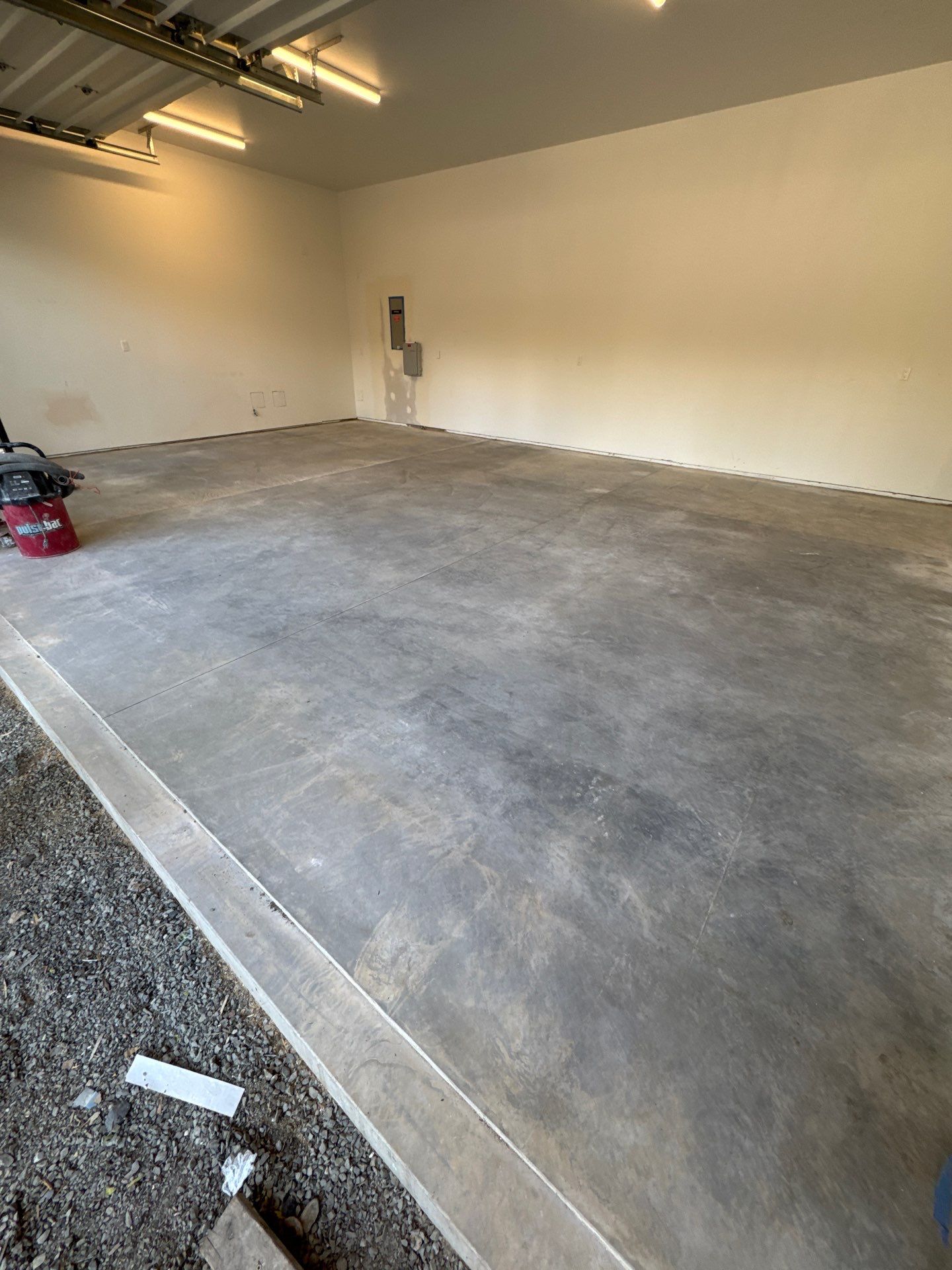 Bare scuffed concrete garage floor after a remodel in Bellevue before coating