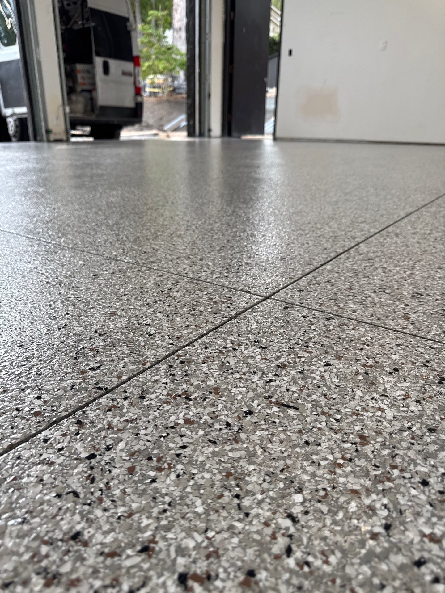 Close-up of Coyote flake with white, grey and brown chips on a Bellevue garage floor