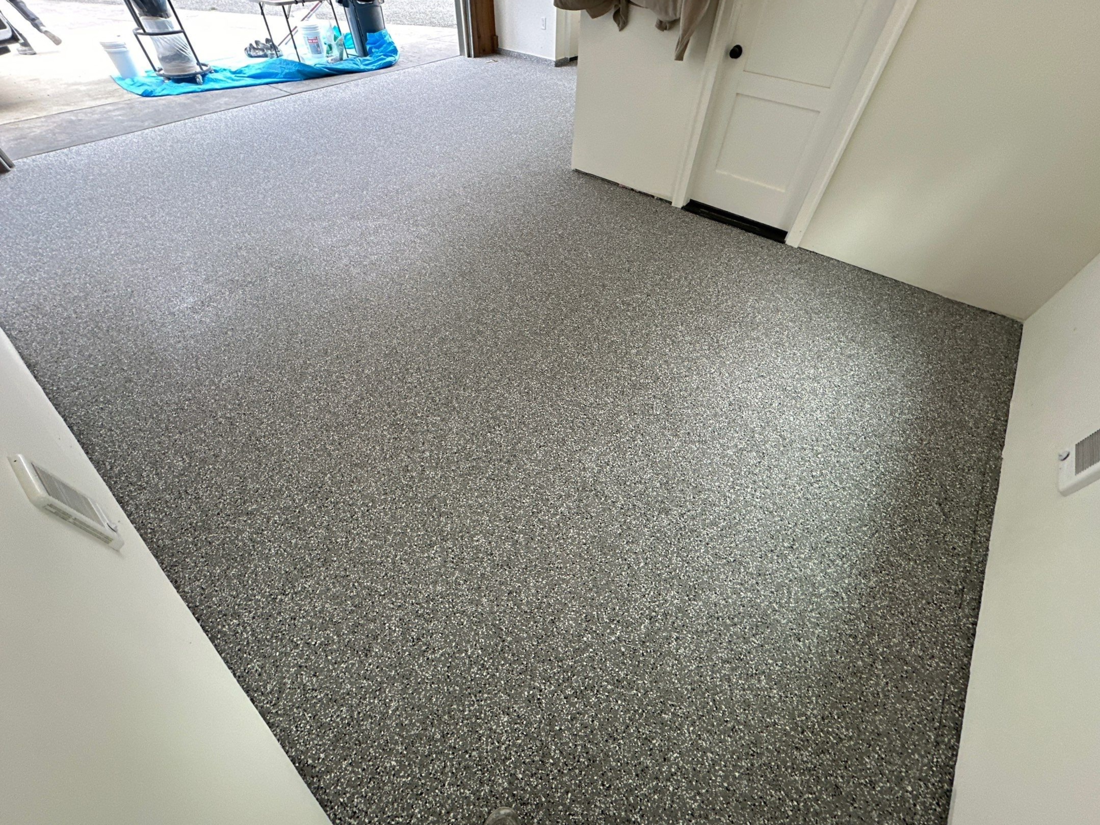 Smoke flake polyurea floor in a Marysville garage room by the house door