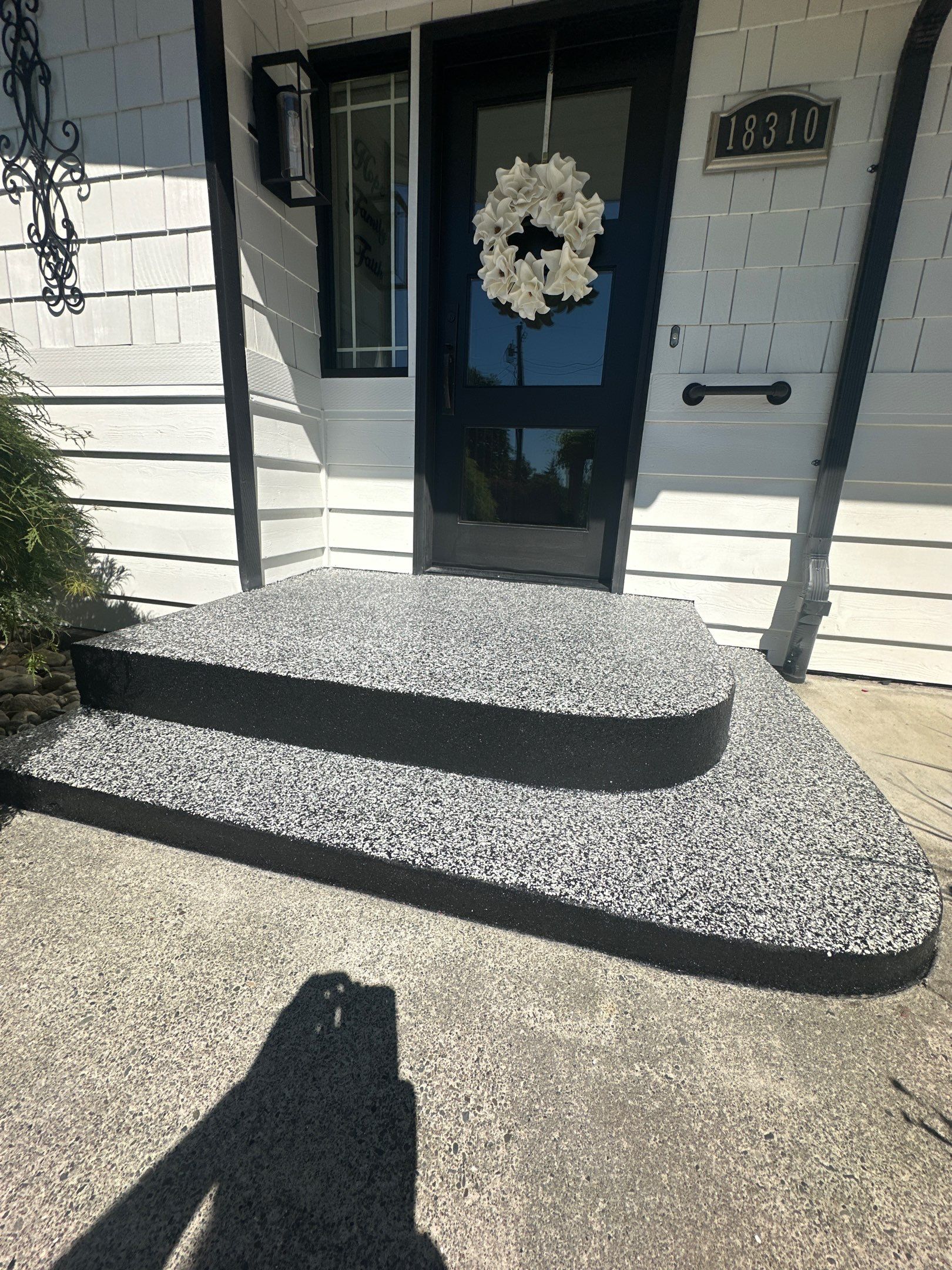 Same Woodinville entry steps after Domino flake coating with black edges