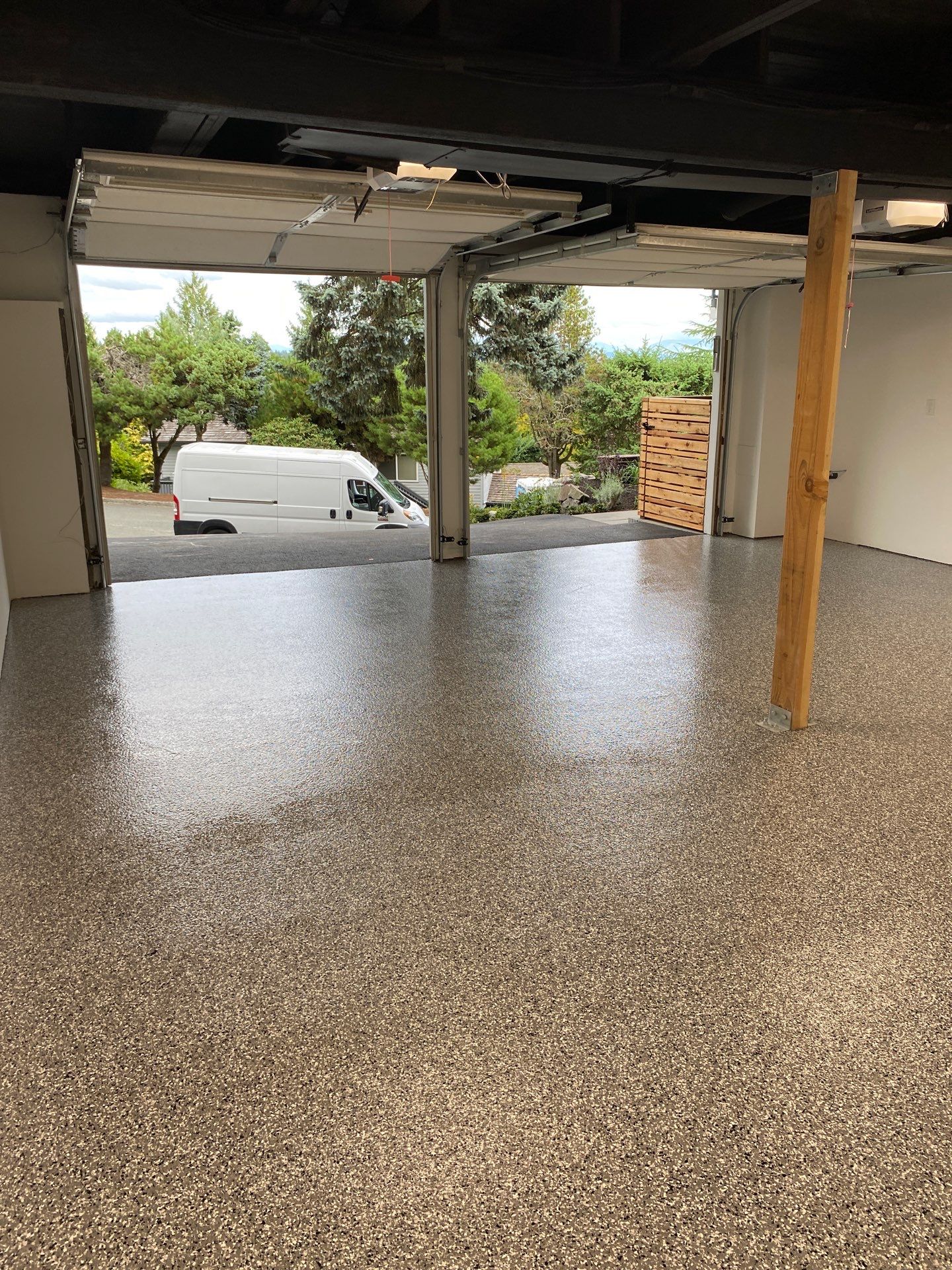 Smoke flake polyurea floor in a long tuck-under garage in Lake Forest Park