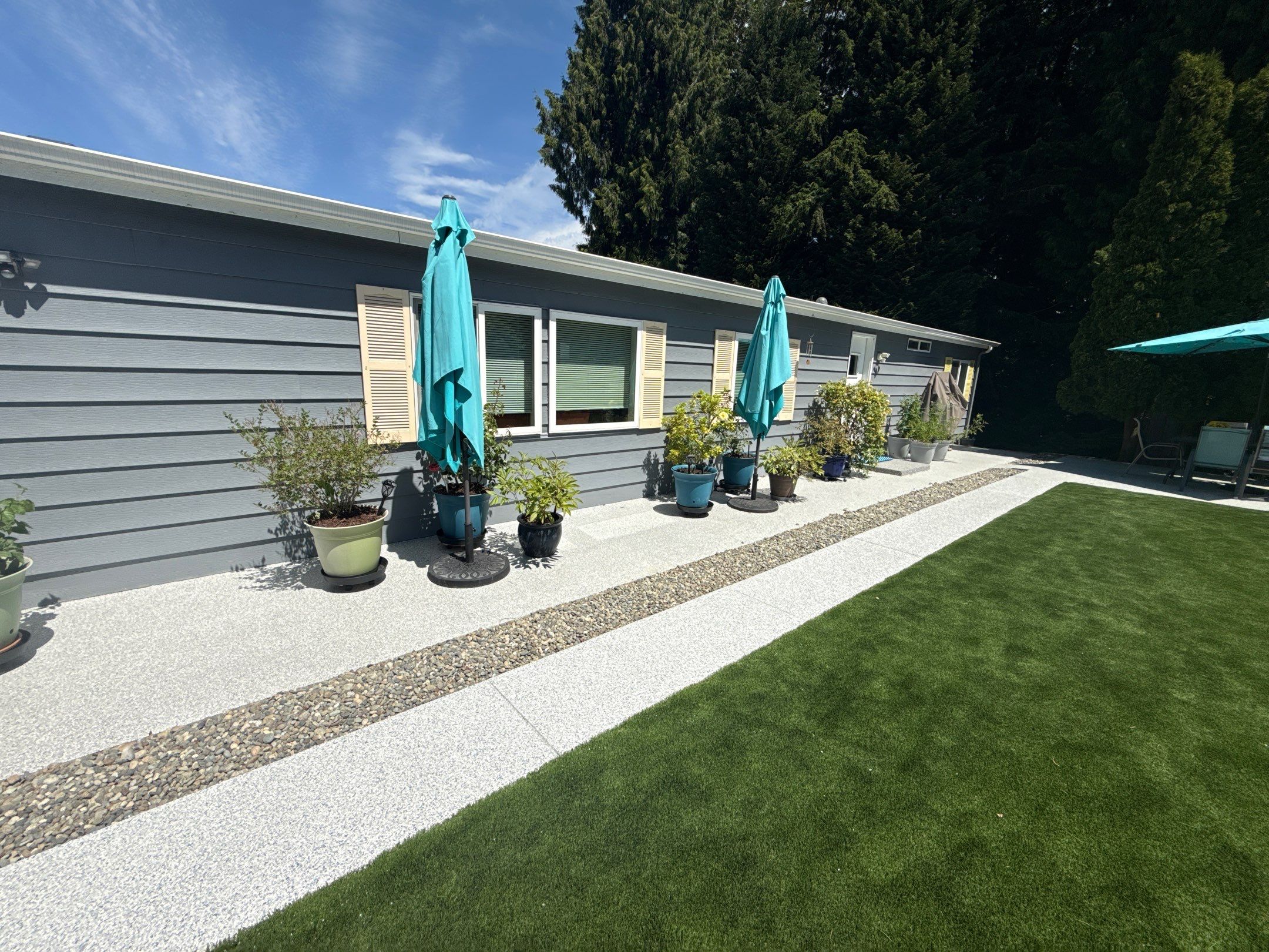 Long Tidal Wave flake walkway between the lawn and potted plants at a Bothell house