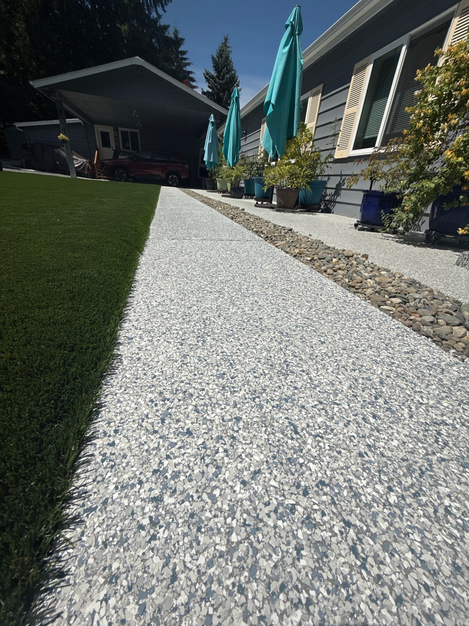 Tidal Wave polyurea walkway along the lawn edge toward a Bothell backyard