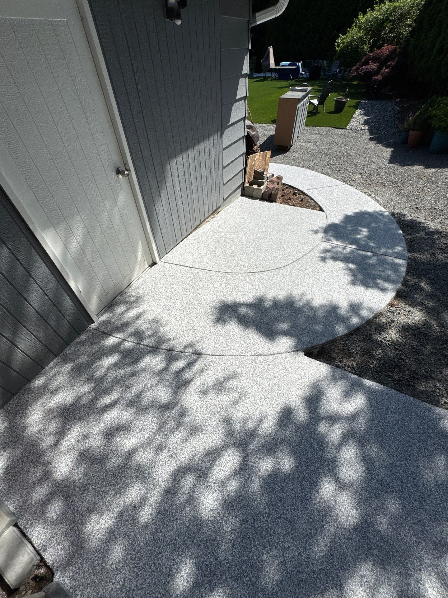 Tidal Wave flake path curving around the side door of a Bothell home