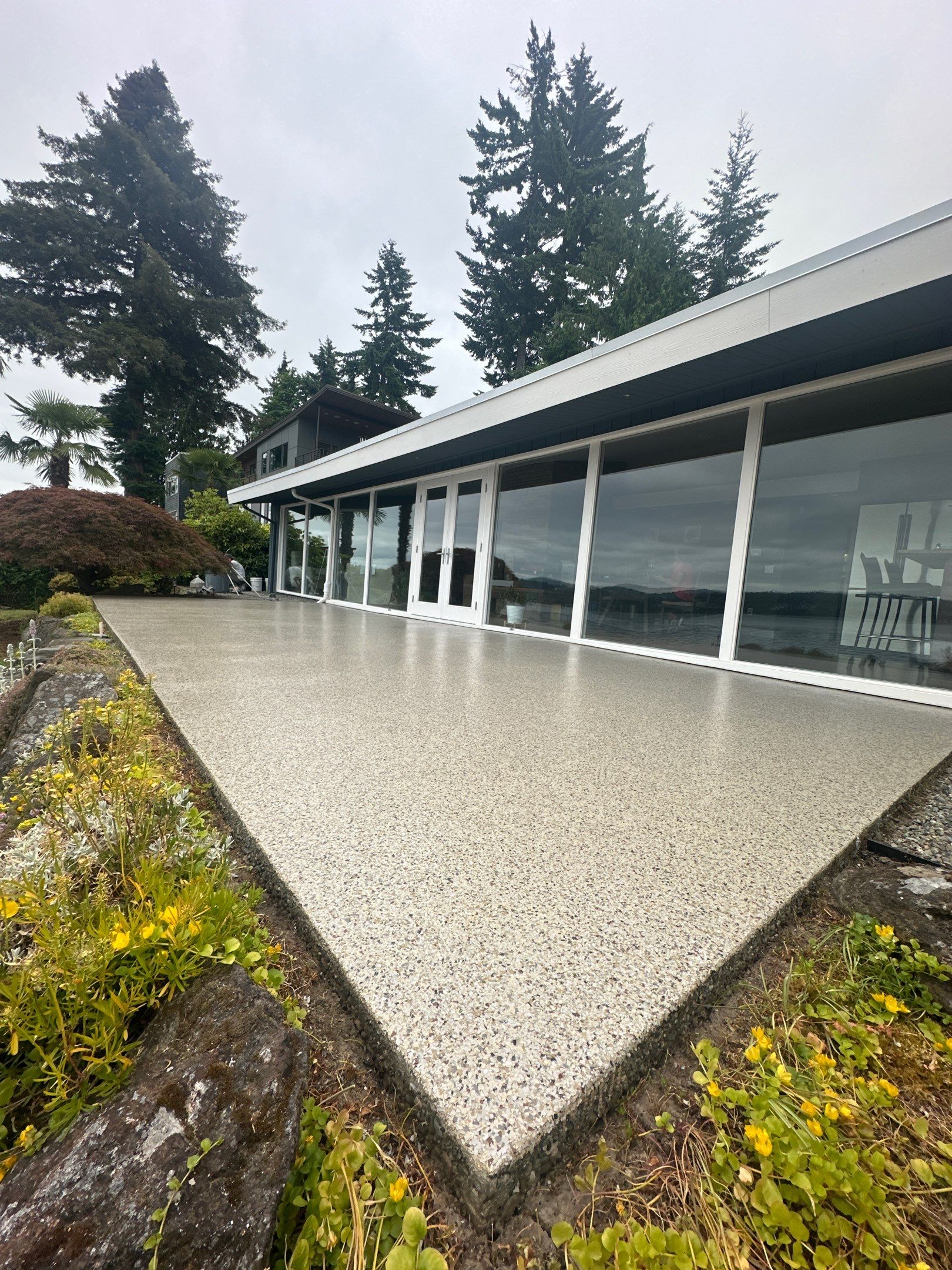 Glossy custom flake patio running the length of a Seattle lake house