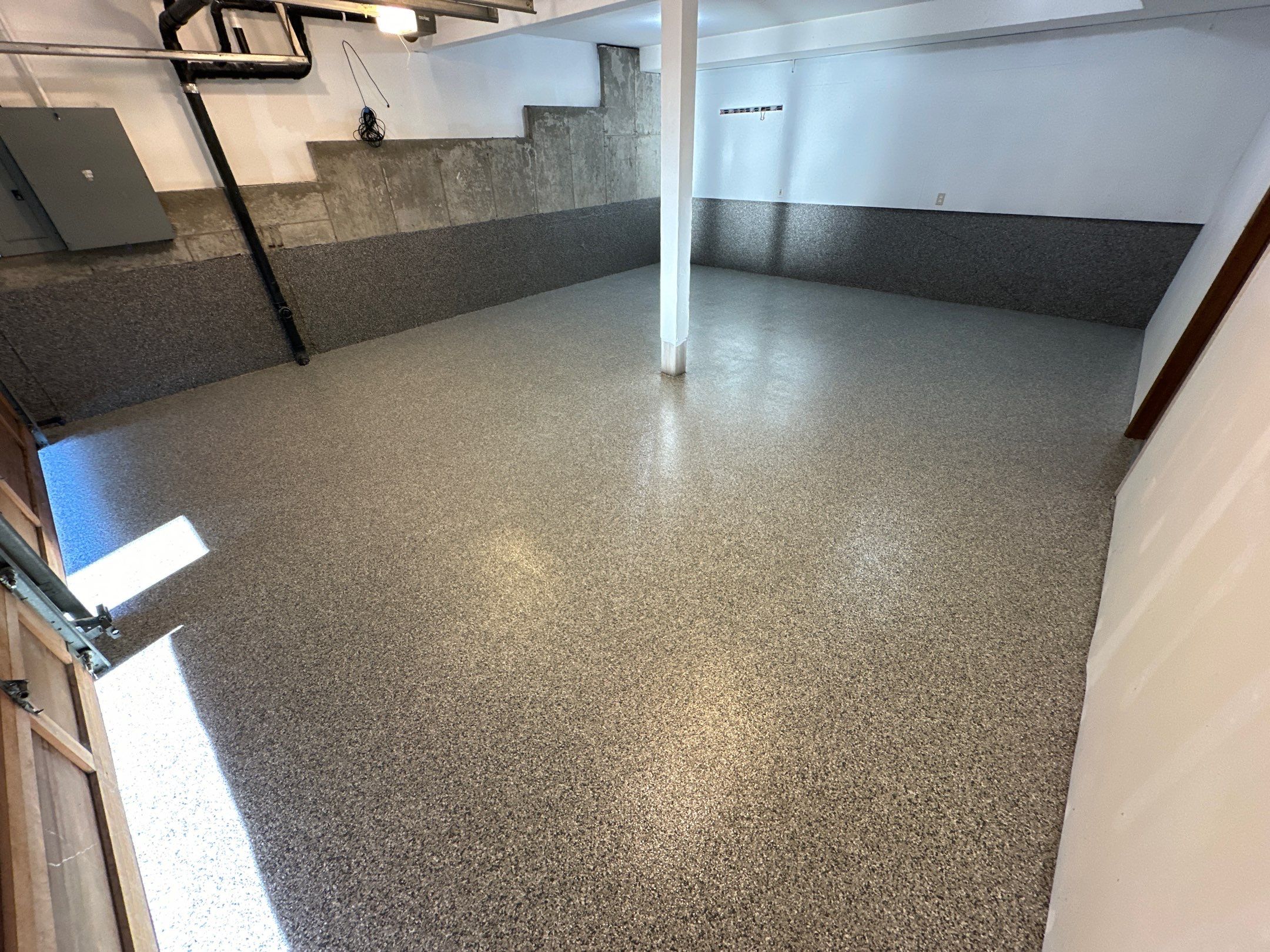 Shoreline hillside garage with coated floor and lower concrete walls in grey flake polyurea