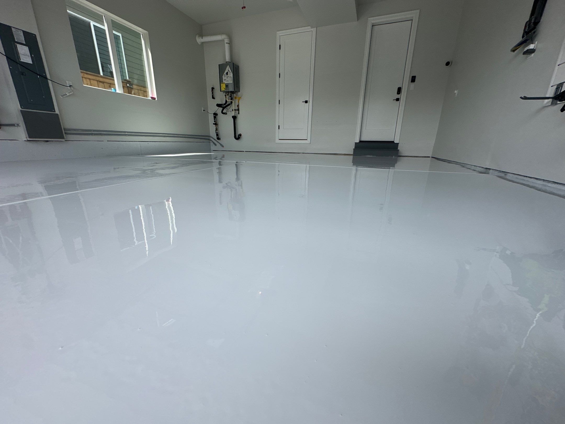 Bright Olympus White polyurea finish across an organized Sammamish garage