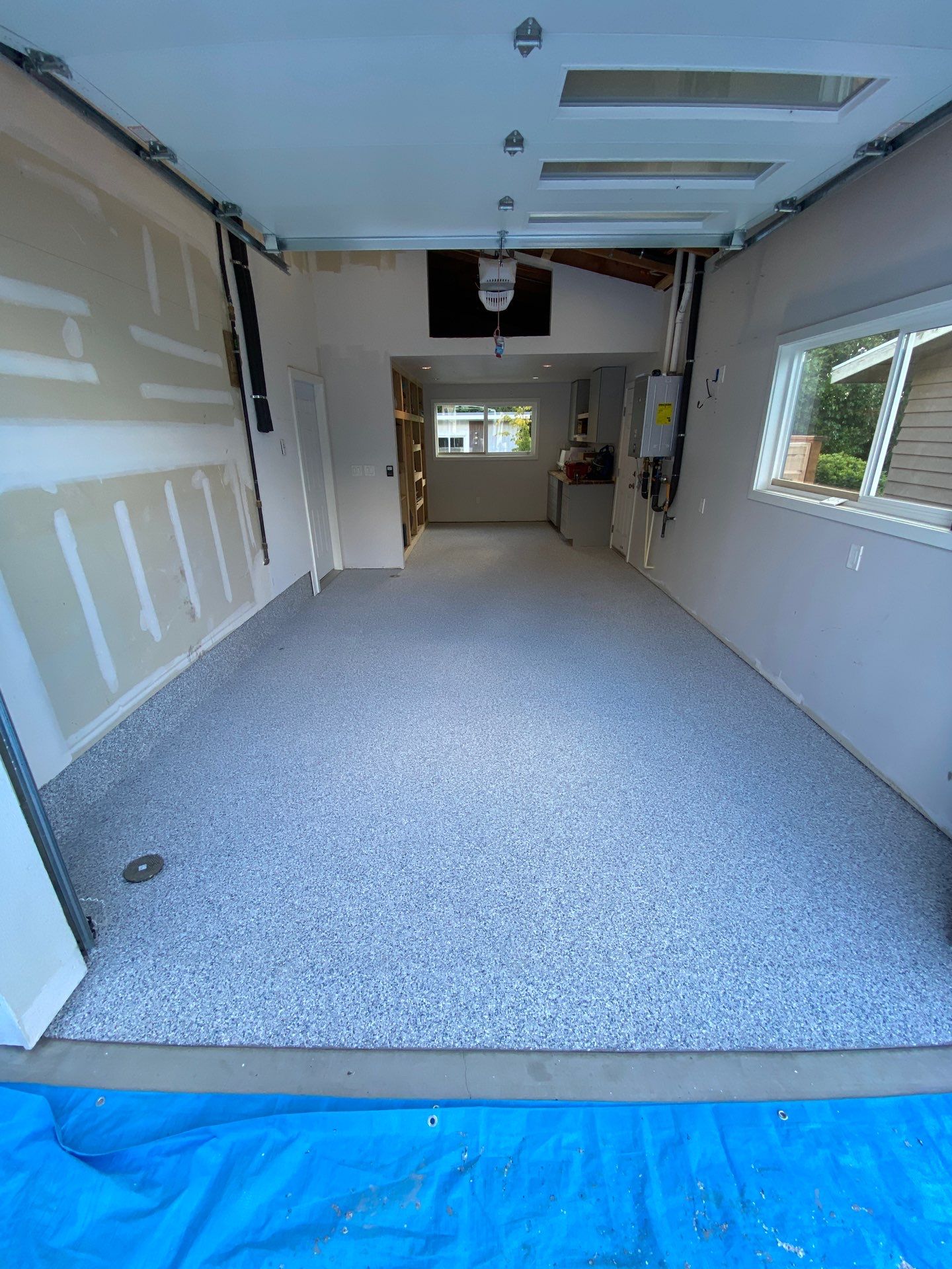 Tidal Wave flake polyurea floor in a long tandem garage in Mountlake Terrace