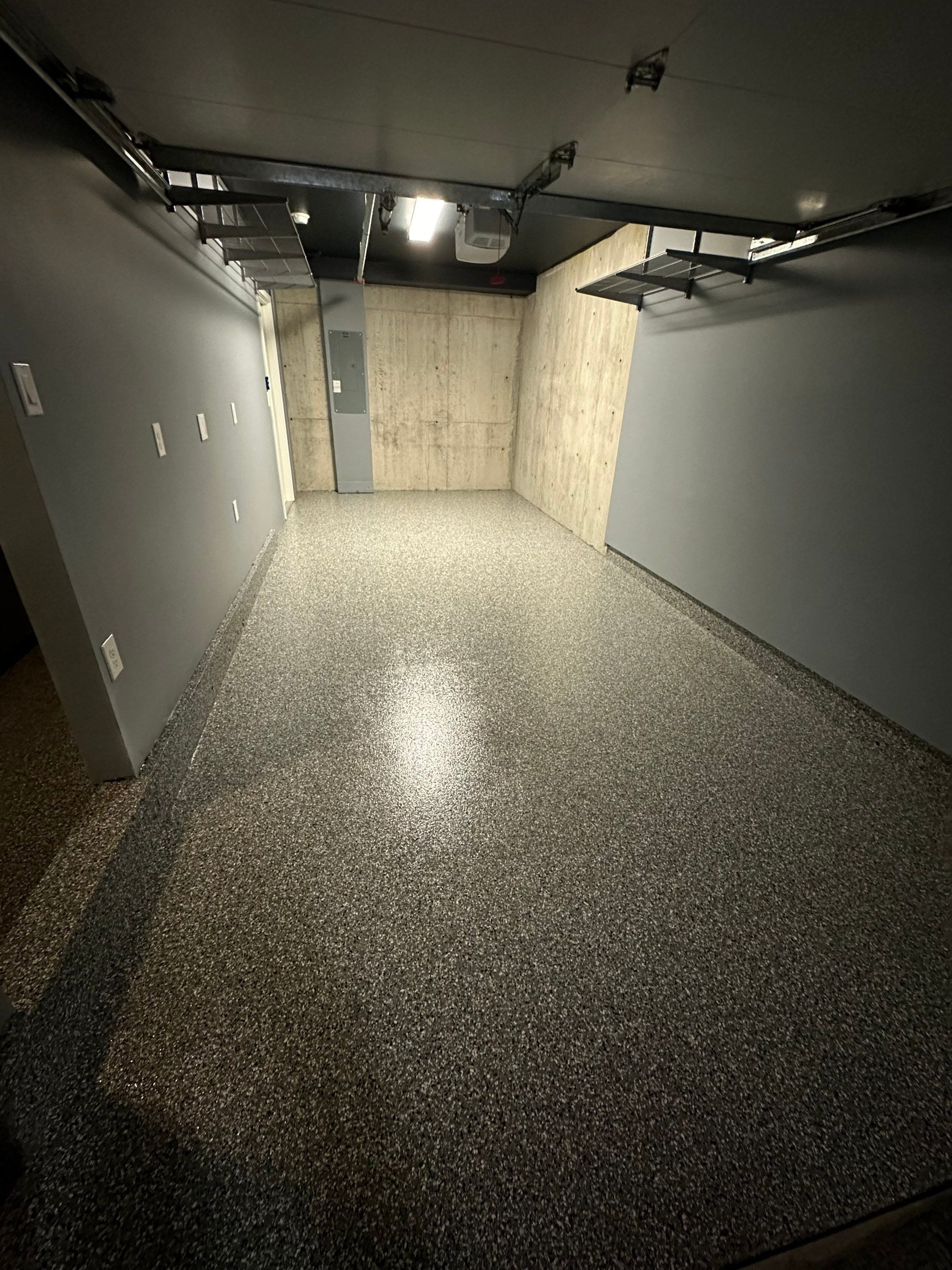 Long narrow Seattle garage with a glossy Smoke flake polyurea floor