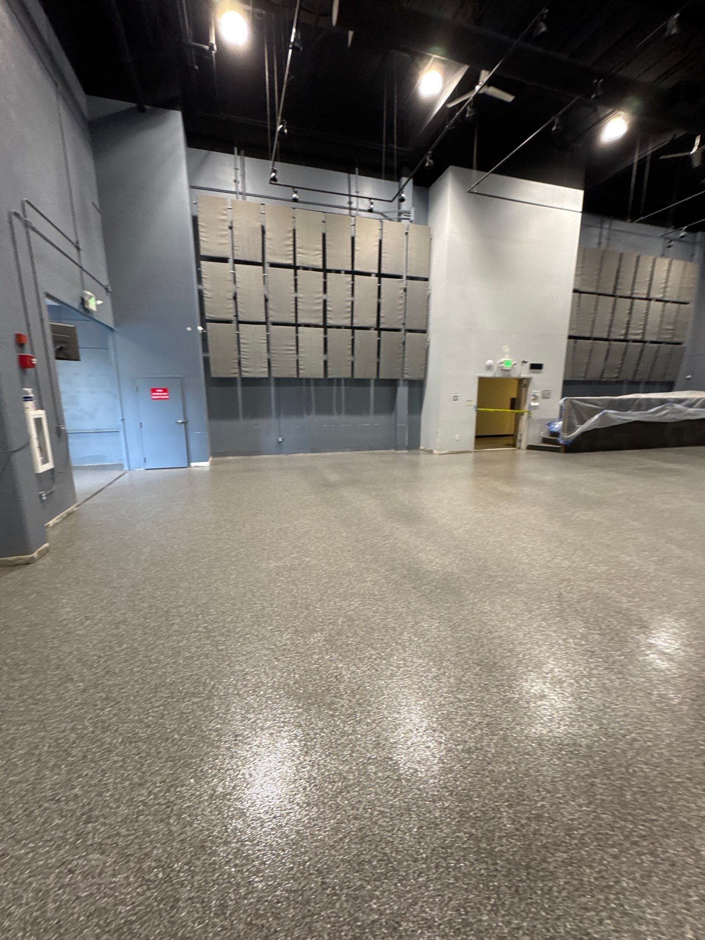 Silver Creek flake polyurea floor in a Bellevue event space with acoustic wall panels
