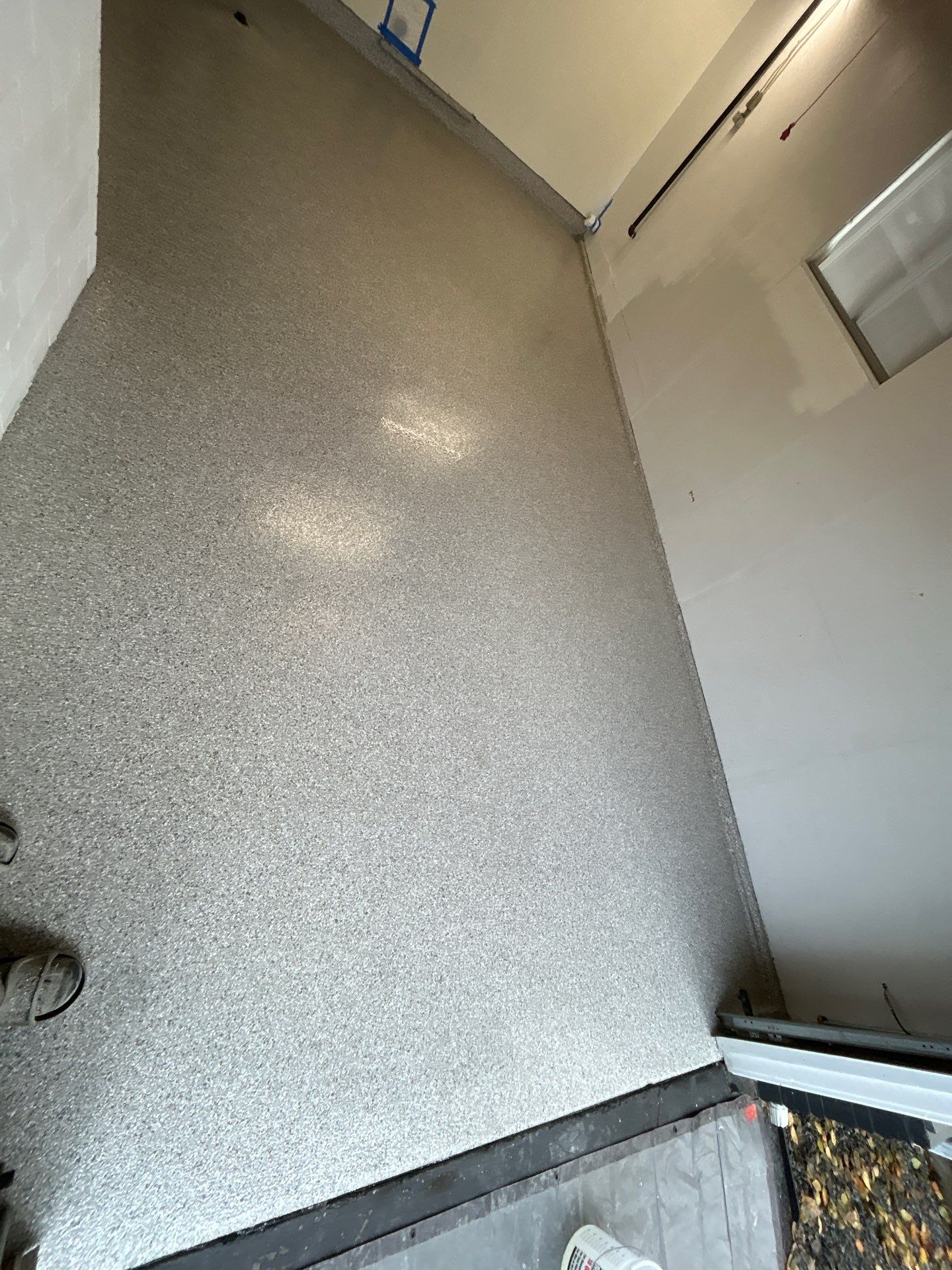 Worn and flaking garage floor paint in Edmonds before the Penntek install