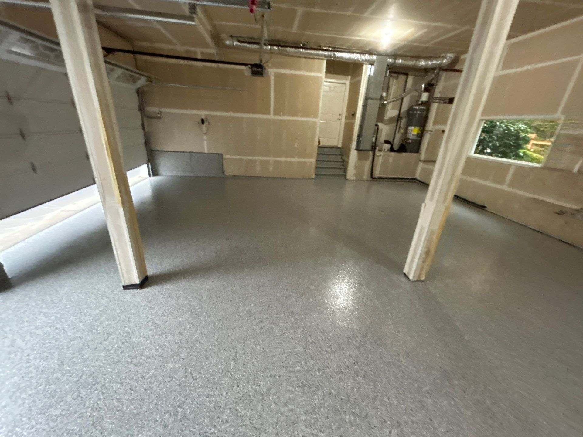 Slate Stone flake polyurea floor in a large Sammamish garage with two support posts