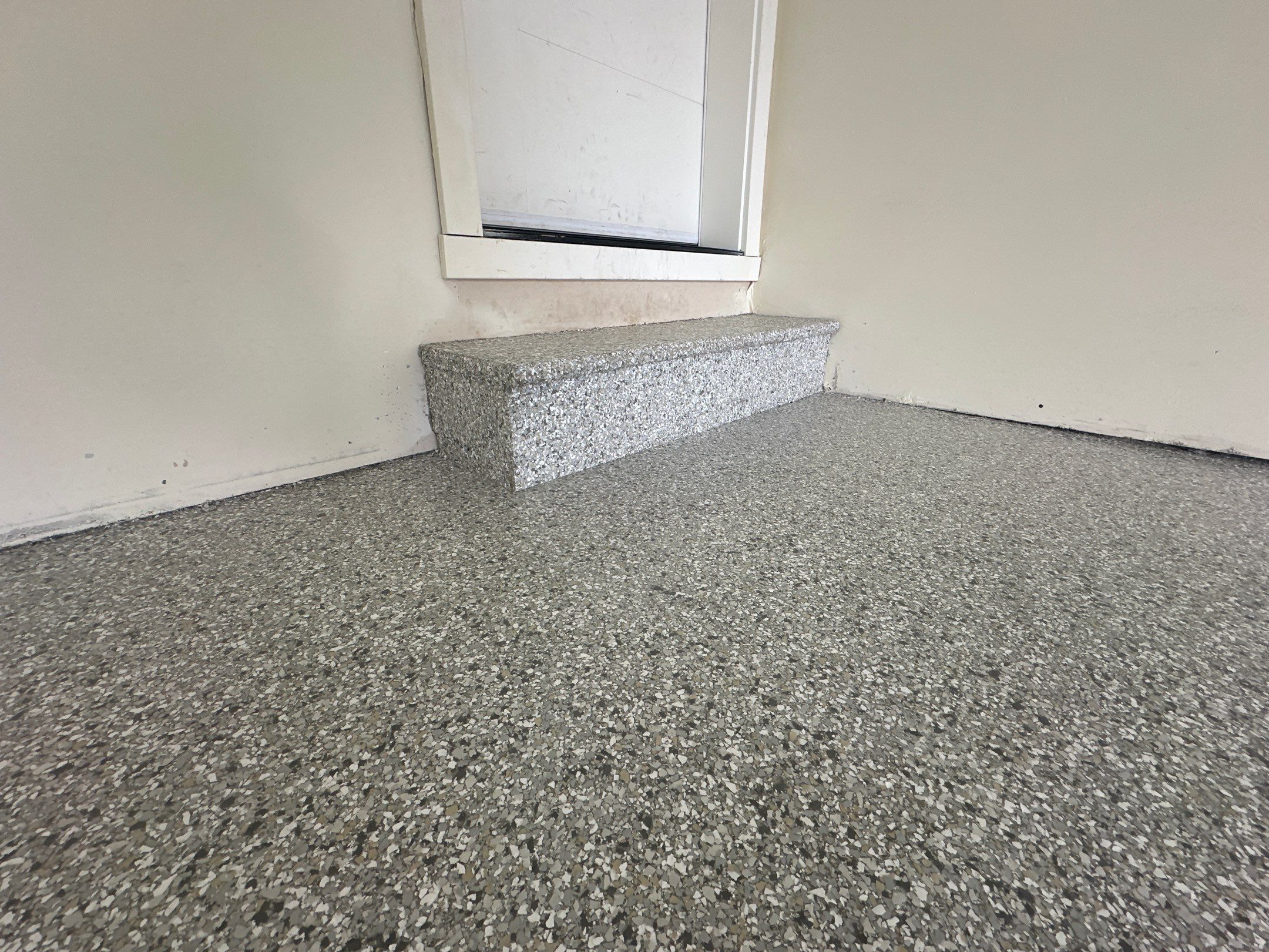 Coated concrete step at the house door in a Bothell garage, Mount Everest flake