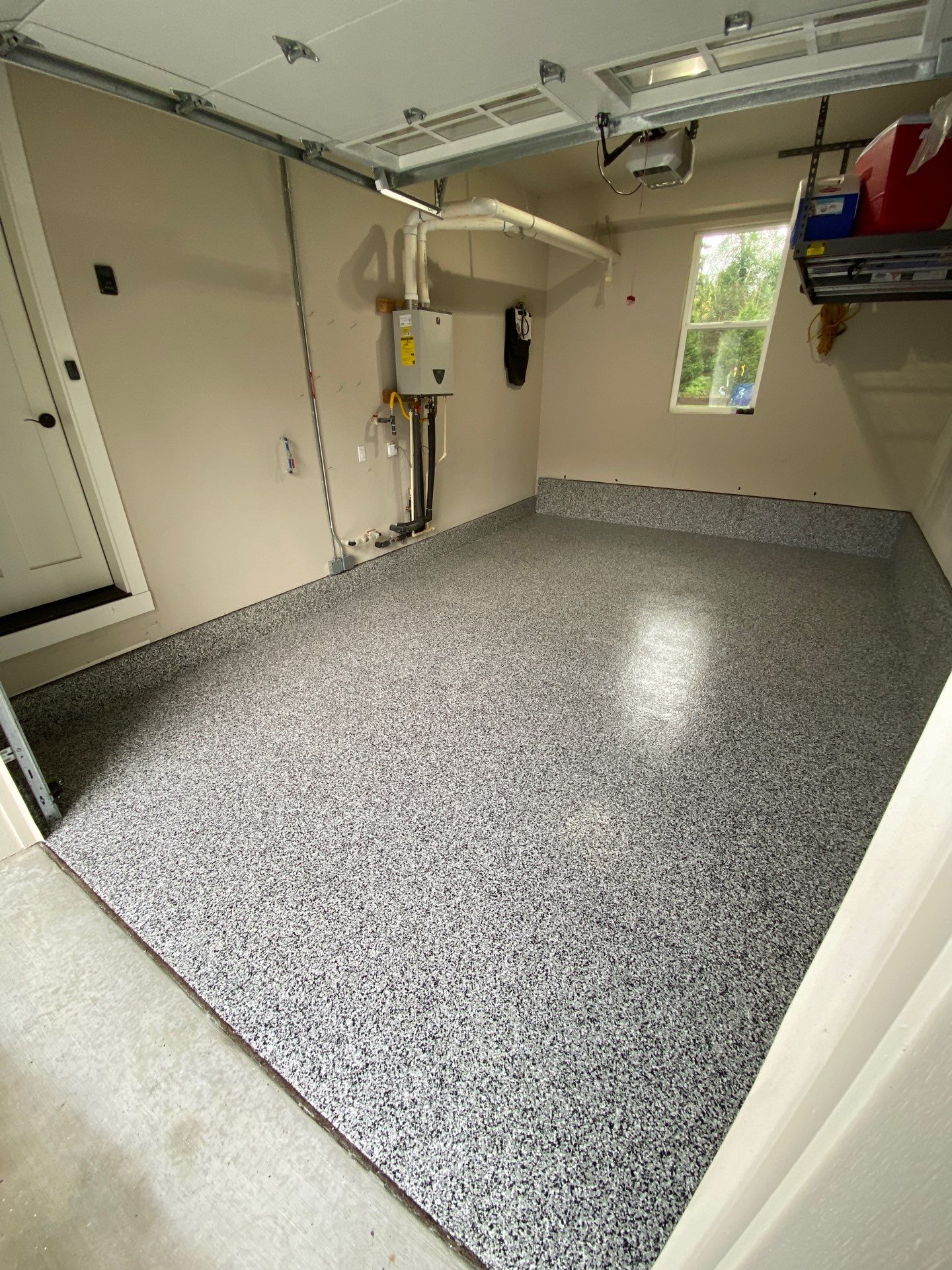 Domino flake polyurea garage floor next to a tankless water heater in Woodinville