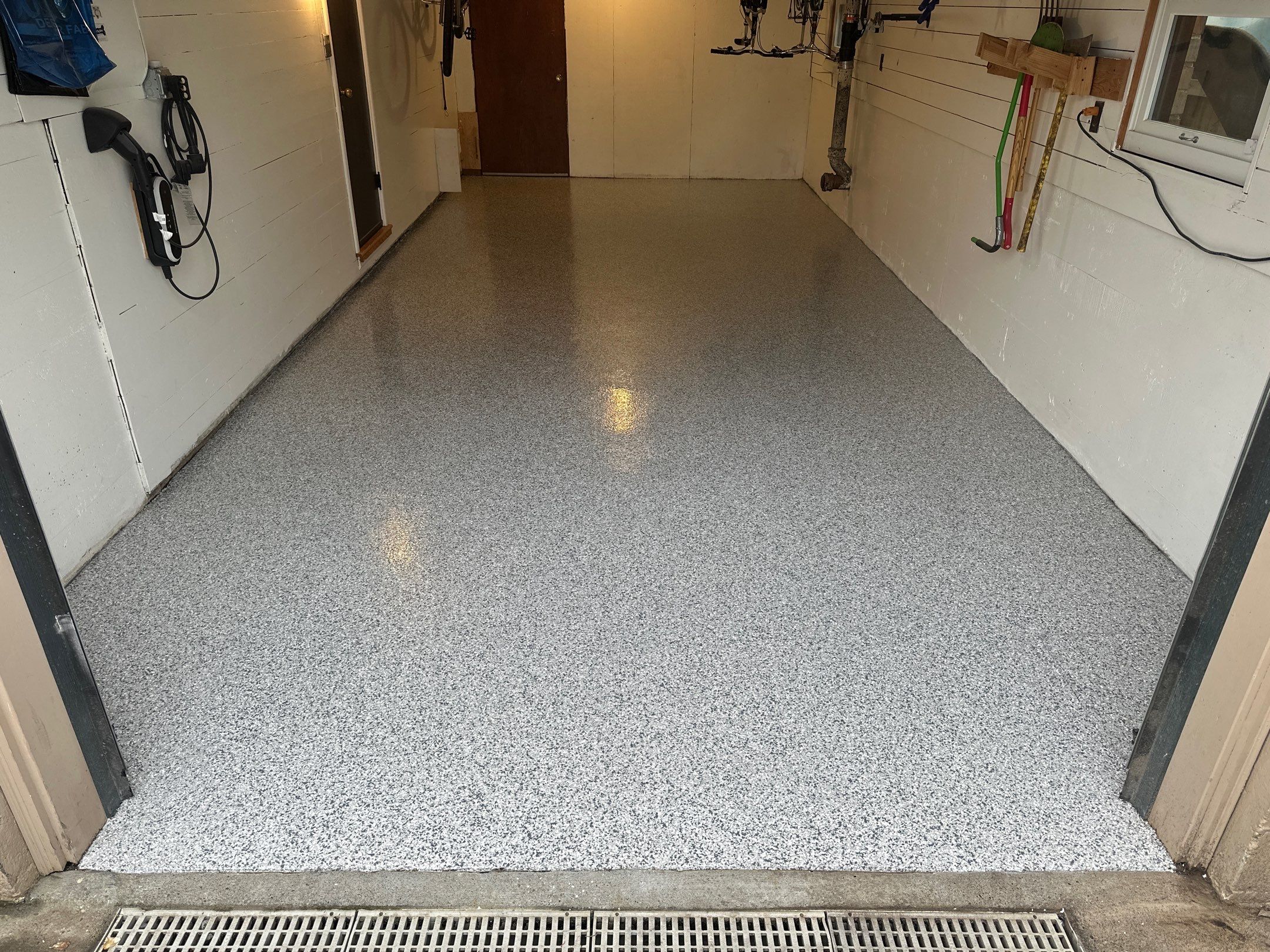 Long narrow Seattle garage with Slate Stone flake floor and trench drain