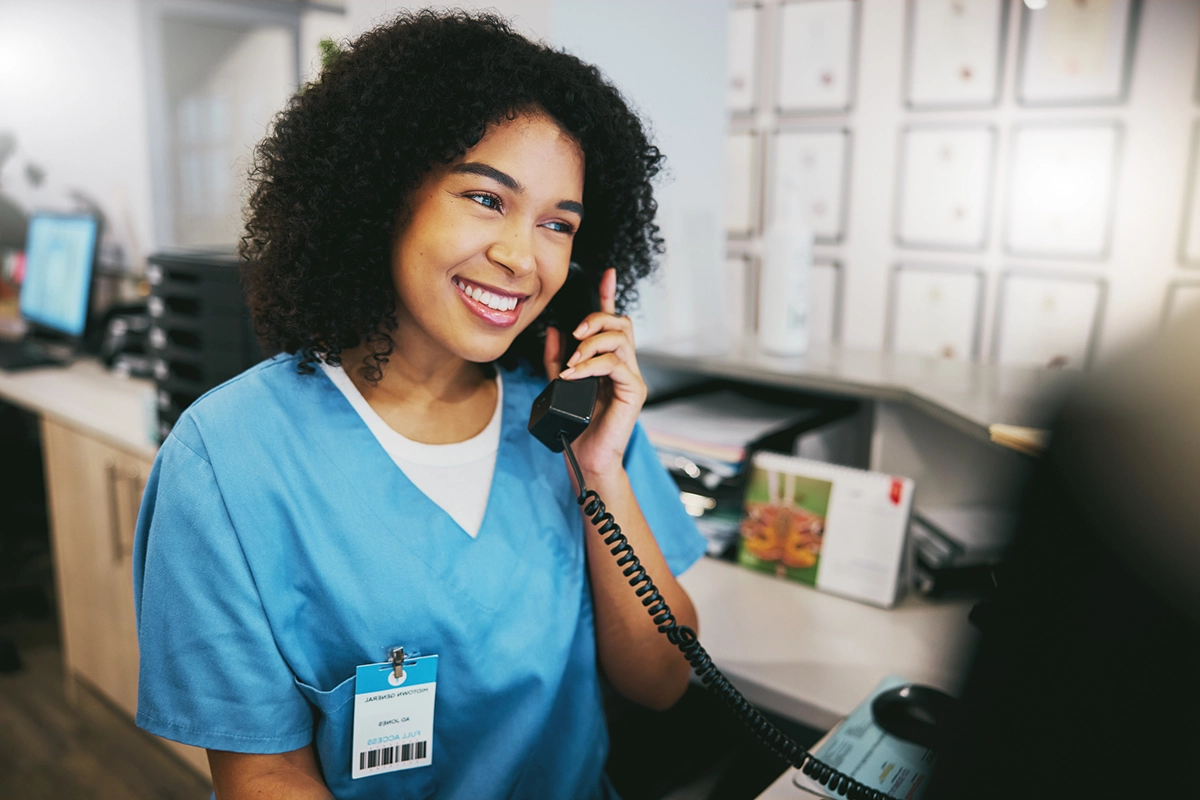 Nurse consultant on a telephone triage headset providing 24/7 workers' compensation injury care
