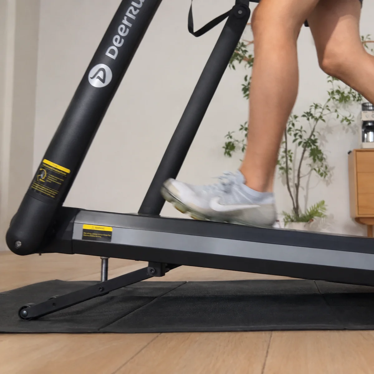 Close-up of the DeerRun X20 raised at incline with a runner on the belt