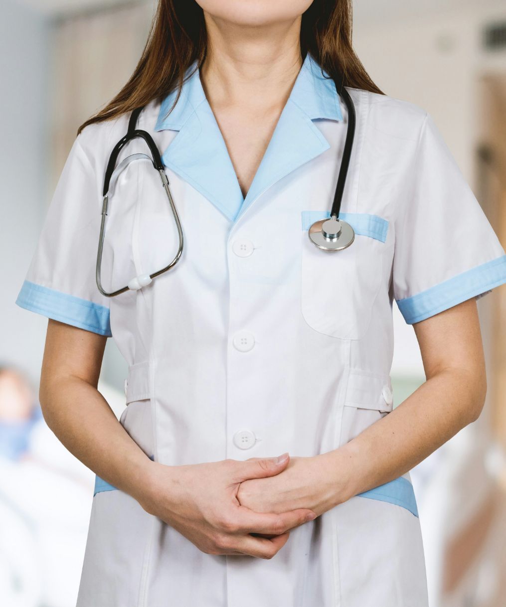 Healthcare professional in white and blue uniform with stethoscope