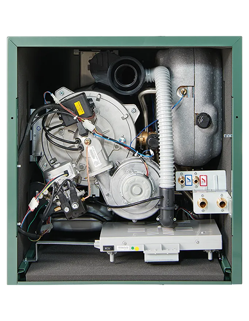 Open view of a green oil boiler showing internal components including wiring, pipes, and a metal tank.