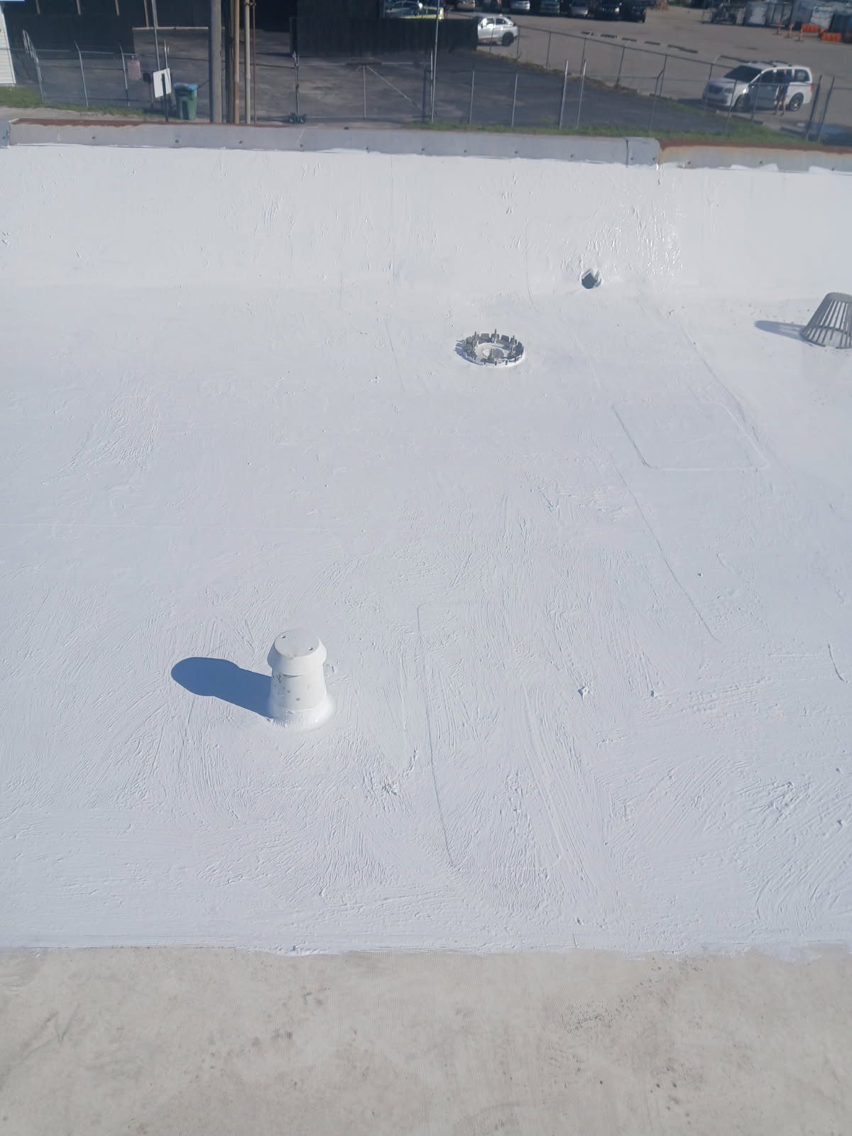 Fabricate and install custom-bent galvanized coping to finish the parapet edge.