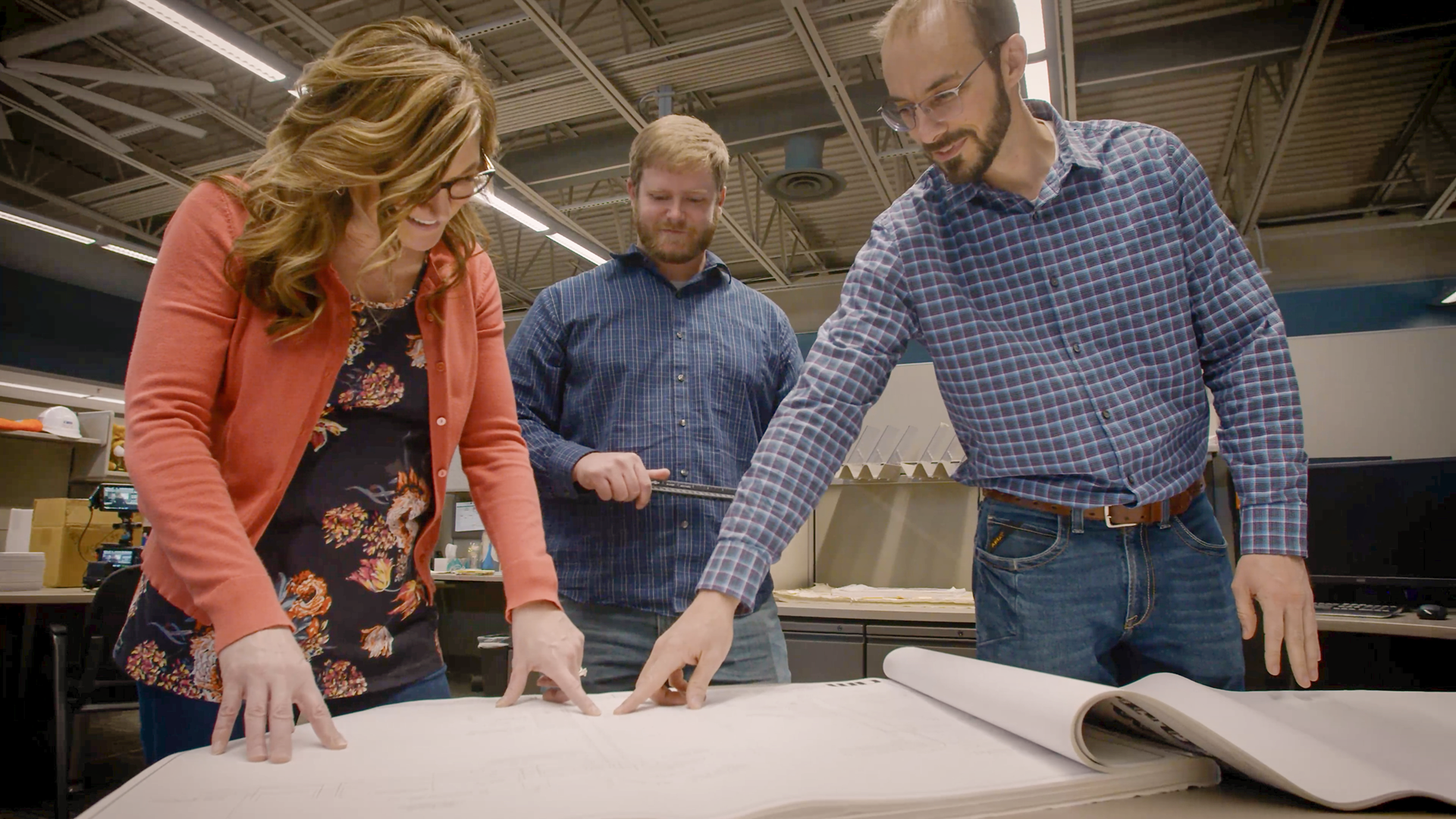 Some engineers looking at diagrams.