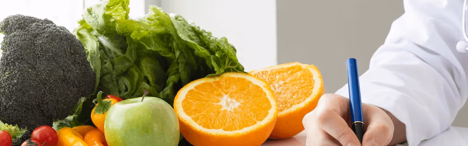 Fresh fruits and vegetables alongside a registered dietitian creating a personalized nutrition plan, showcasing care from the best concierge doctors in Chicago.