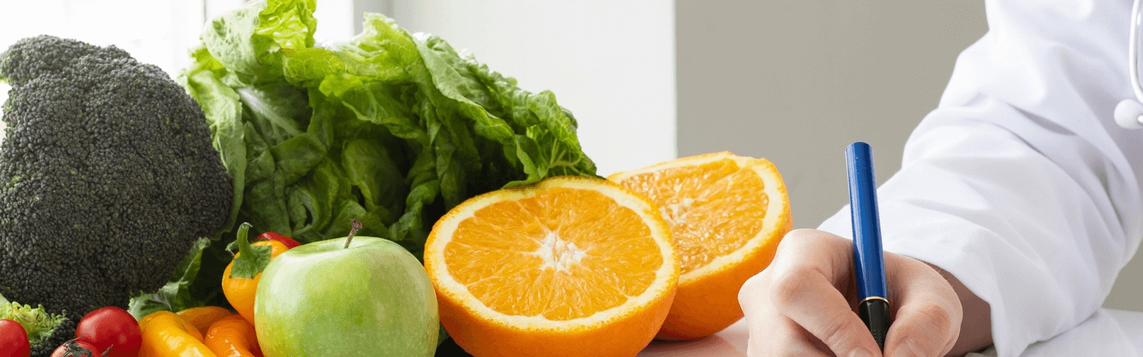 Fresh fruits and vegetables alongside a registered dietitian creating a personalized nutrition plan, showcasing care from the best concierge doctors in Chicago.