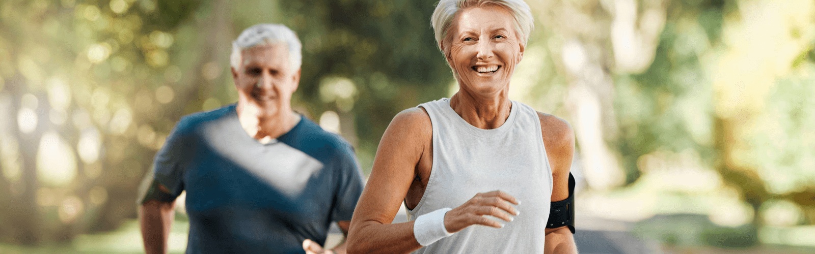 Active older couple jogging outdoors, highlighting heart health as an indicator of longevity with guidance from the best longevity medical practice in Chicago, IL