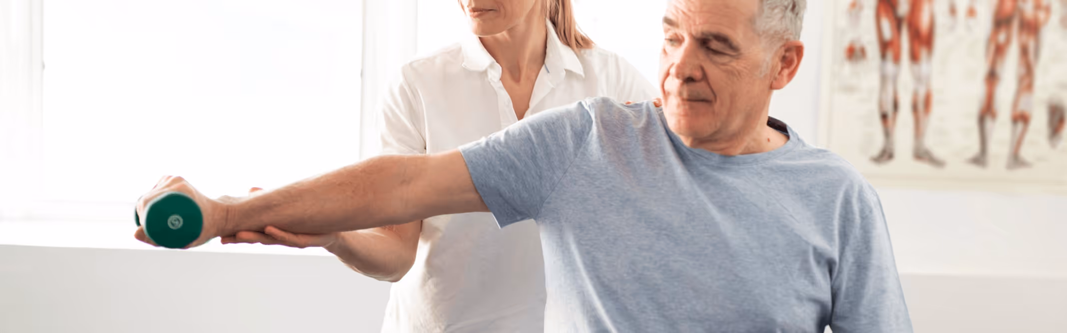 Physical therapist guiding senior patient through arm exercise with weights, advanced physical therapy to improve healthspan at the best physical therapy in Chicago, IL