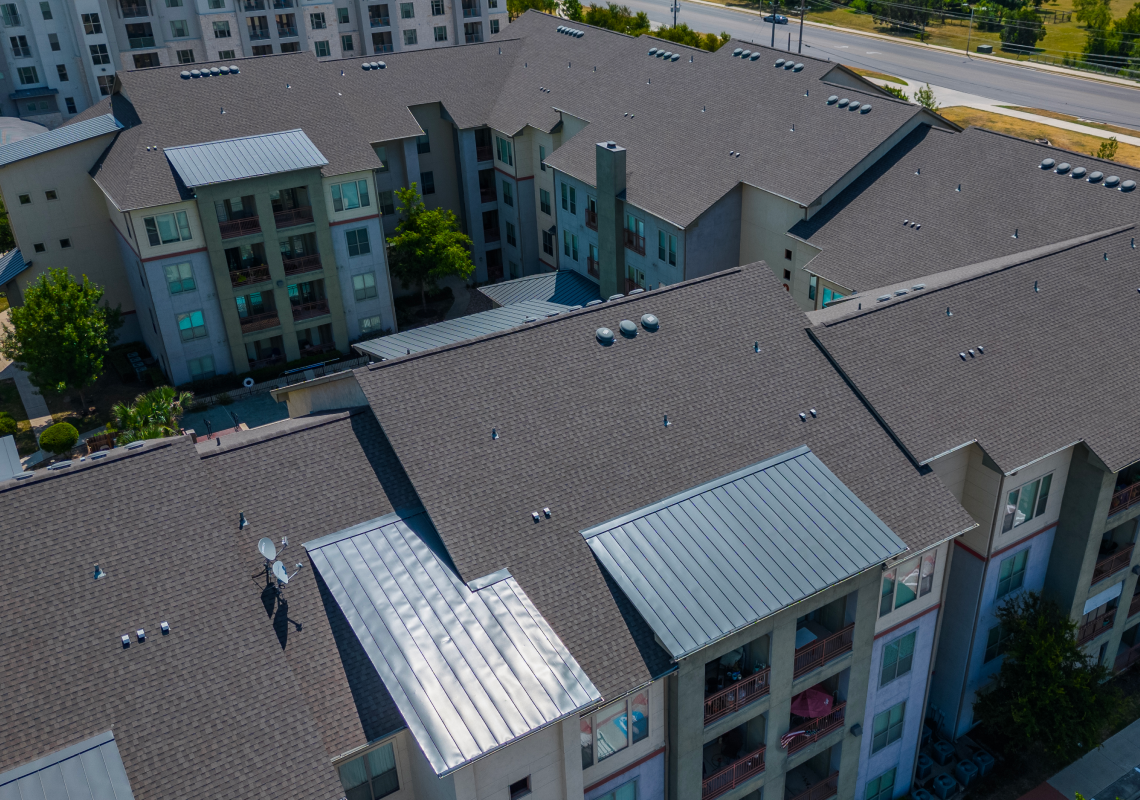 multi-family residential complex with asphalt shingle roofing system aerial view