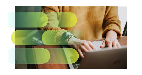 Person wearing a brown sweater typing on a laptop keyboard at a wooden table with semi-transparent colorful horizontal bars overlaid.