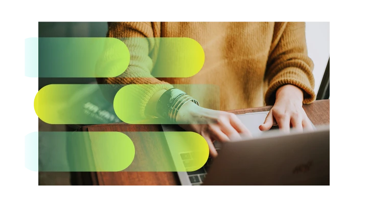 Person wearing a brown sweater typing on a laptop keyboard at a wooden table with semi-transparent colorful horizontal bars overlaid.