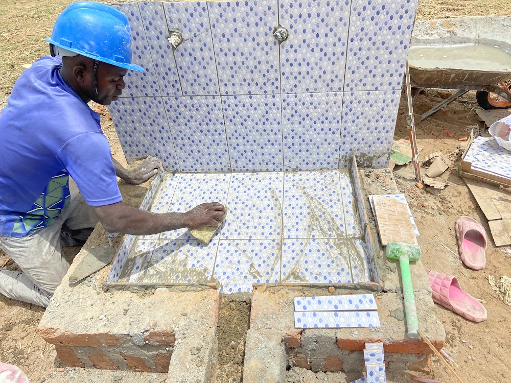After a Neverthirst gathering of partners from both Africa and Asia, Africa teams are testing adding tile to tap stands for both improved aesthetics and helping make them easier to remove debris.