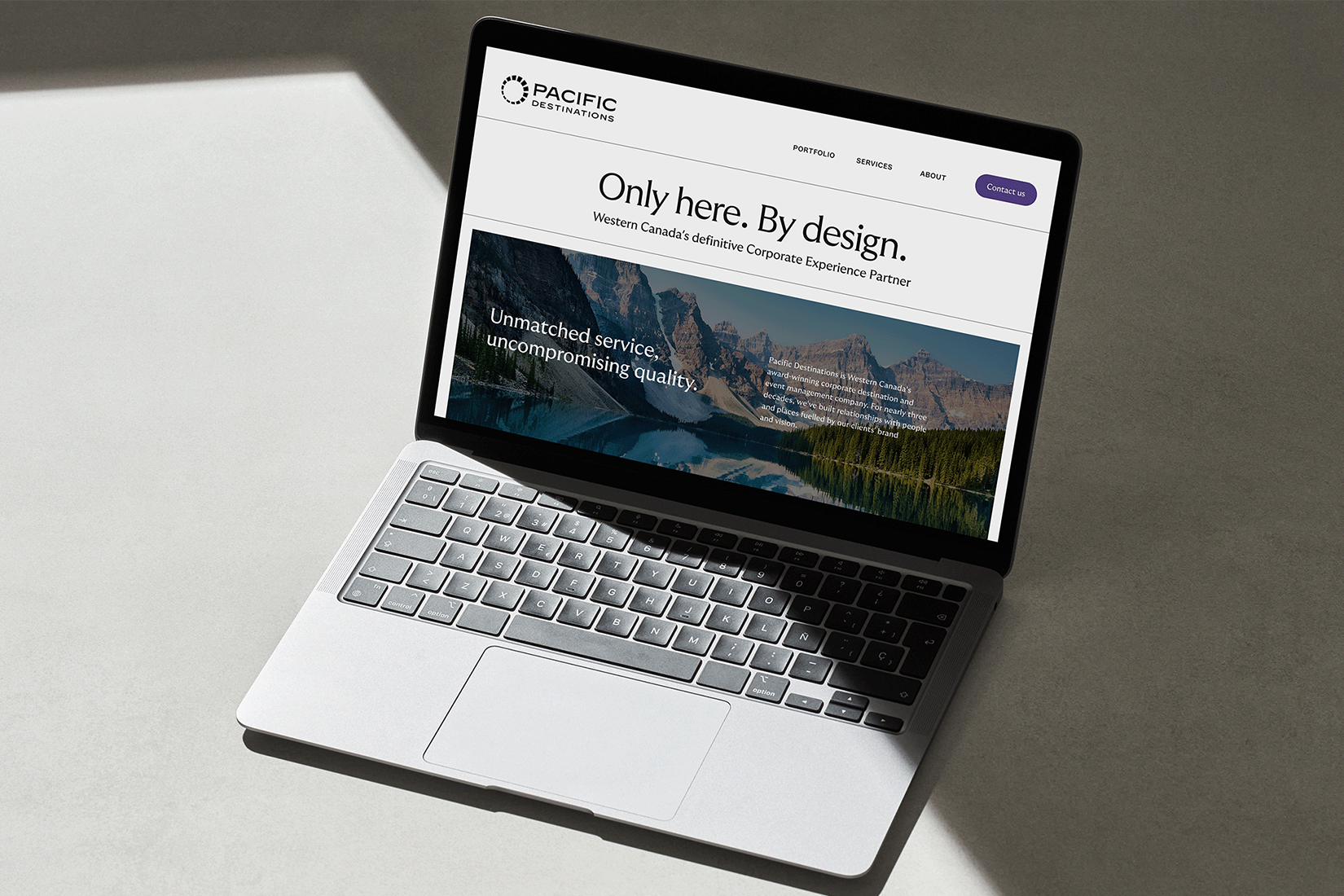 Open laptop showing Pacific Destinations website with text about service quality.