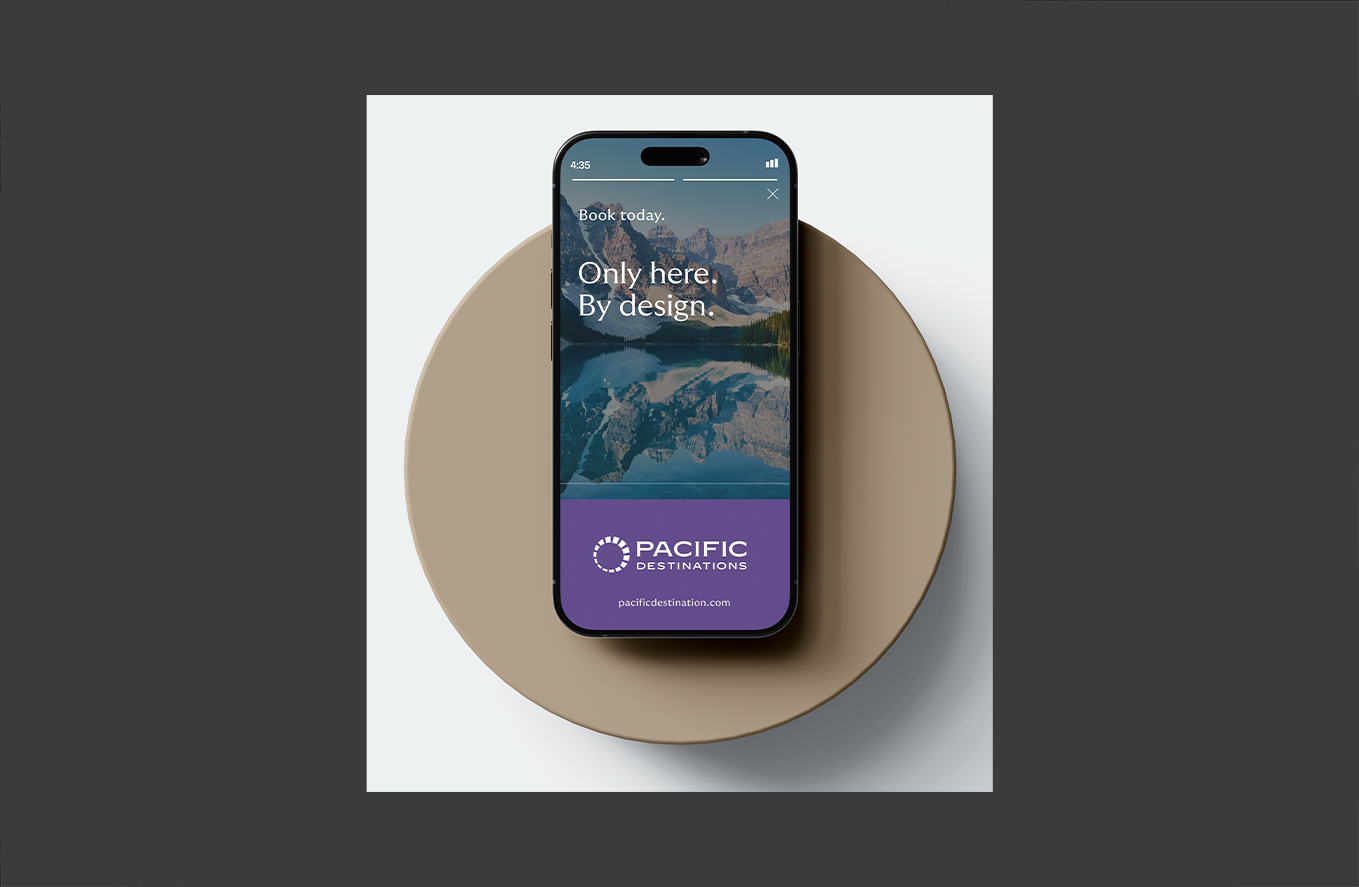 Smartphone showing scenic mountains and lake with text: Only here. By design.