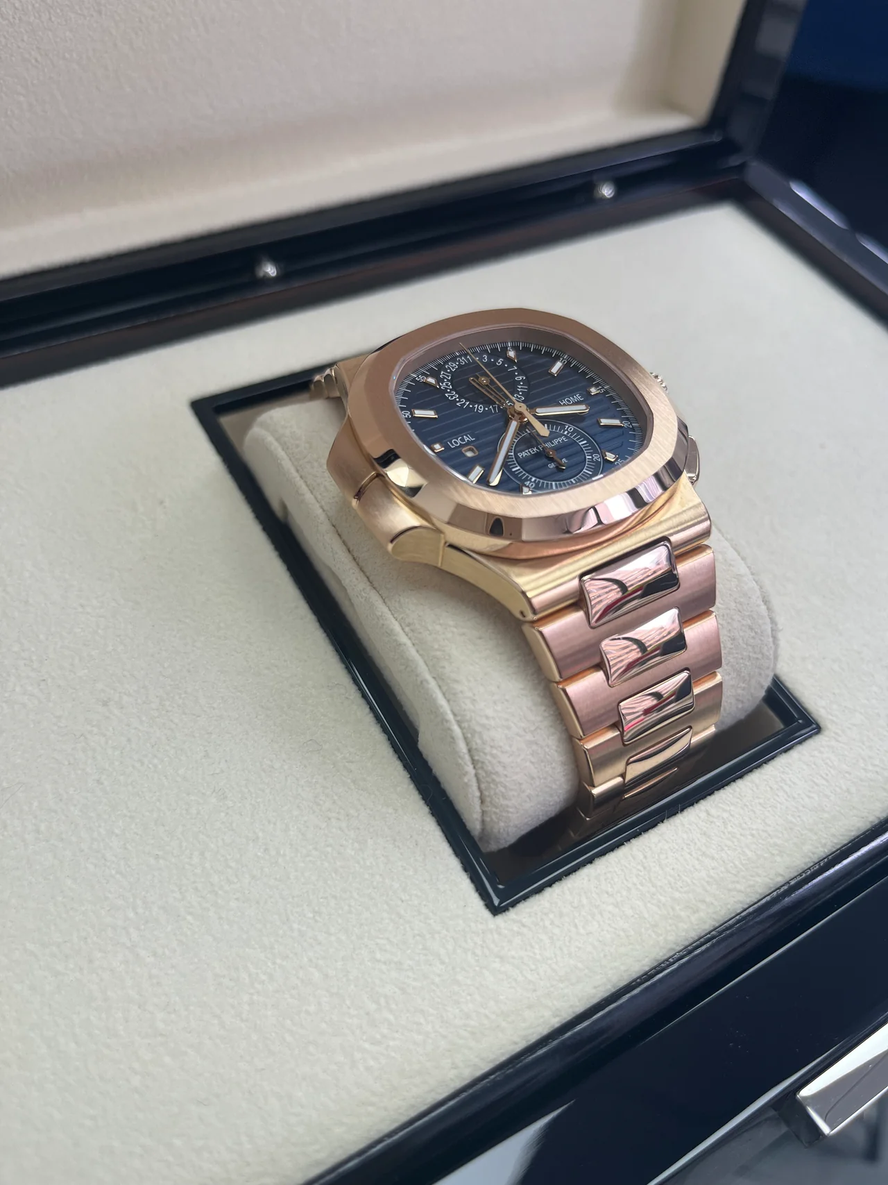 Patek Philippe Nautilus 5990/1R in rose gold featuring a sunburst blue dial and flyback chronograph complication.