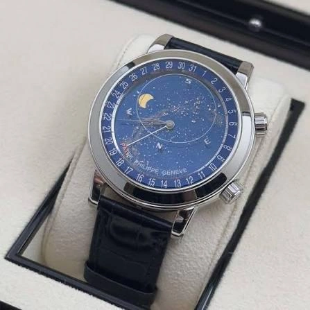 Close-up detail of a Patek Philippe 6102P Celestial watch dial featuring the blue sapphire crystal sky chart, Milky Way constellation, and moon phase complication in a platinum case.