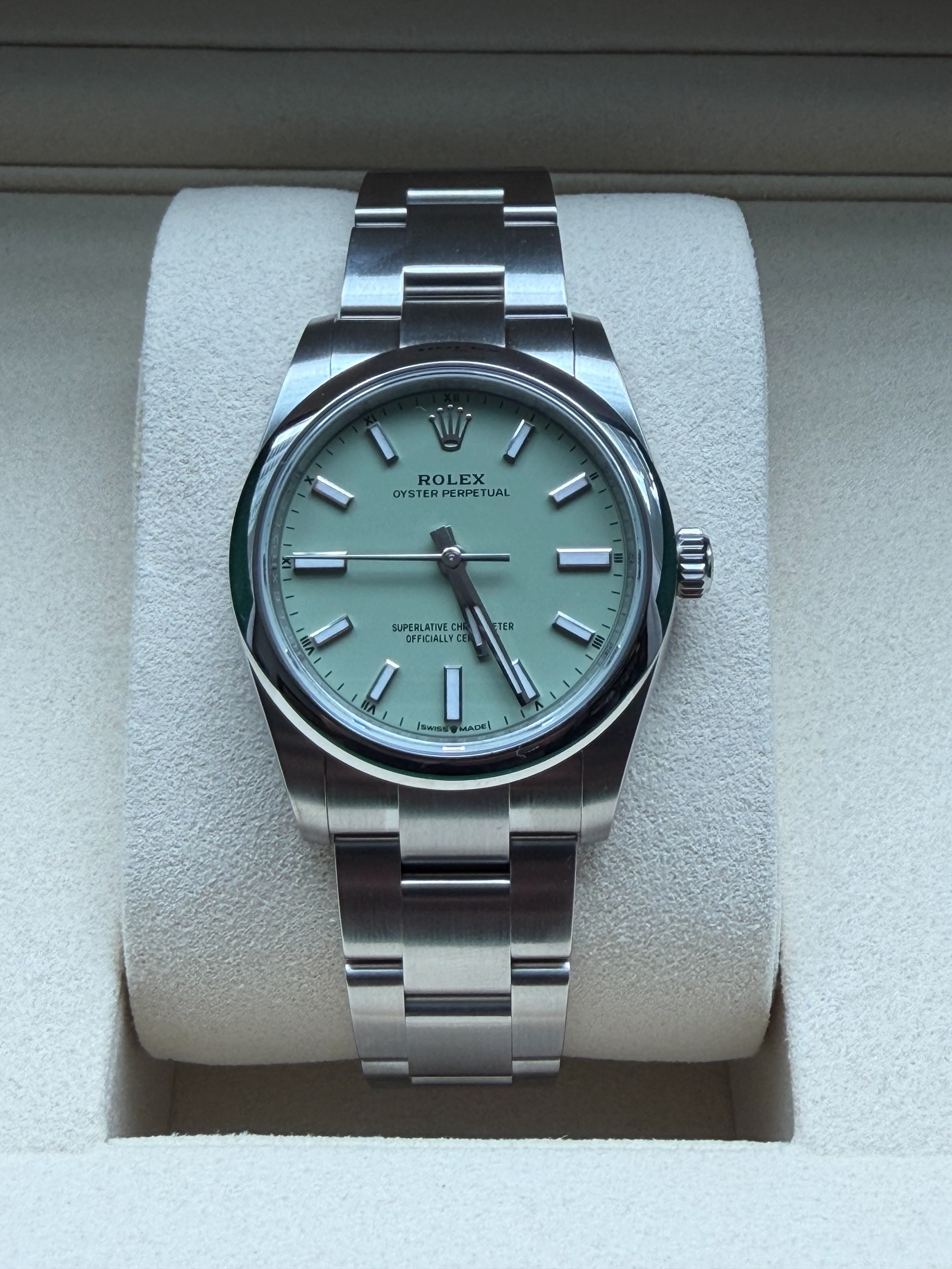 Front view of the Rolex Oyster Perpetual 34 Ref. 124200 featuring the distinct pistachio green lacquer dial and baton hour markers
