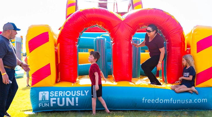 Kids racing through a Freedom Extreme obstacle course rental.