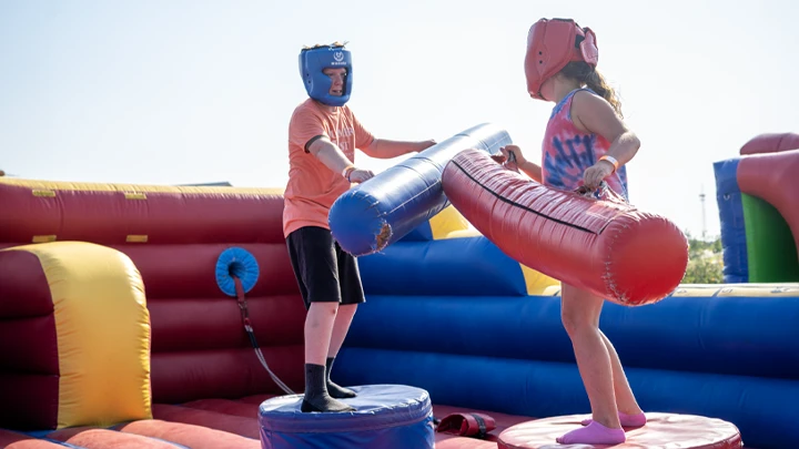 Inflatable joust game rental setup at a church by Freedom Fun USA.