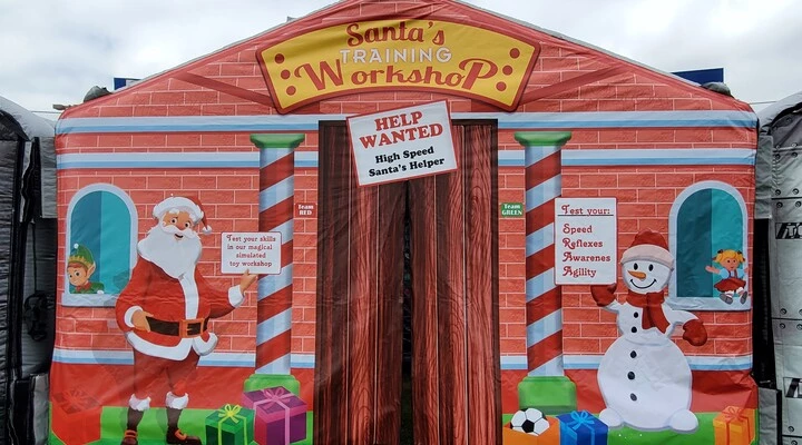 Santa's Workshop holiday inflatable rental at a Christmas event.