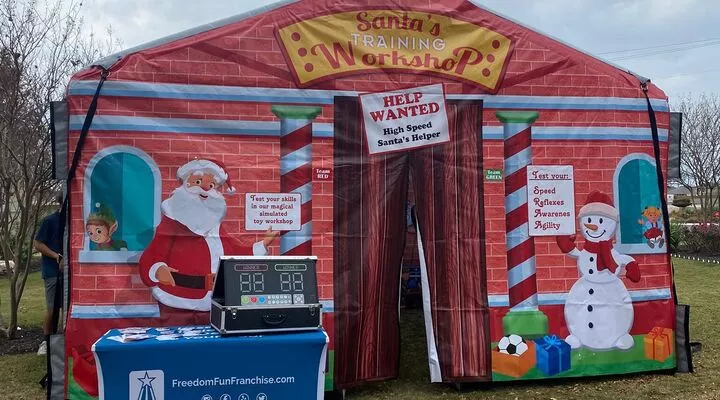 Kids playing inside Santa's Workshop inflatable rental.