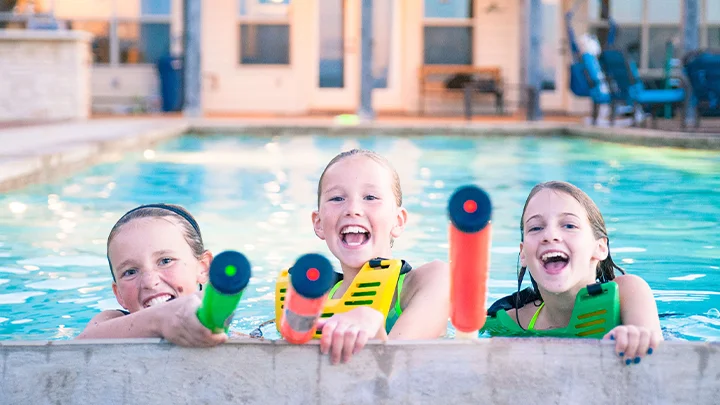 Two girls playing with our water tag rental outside by the pool.