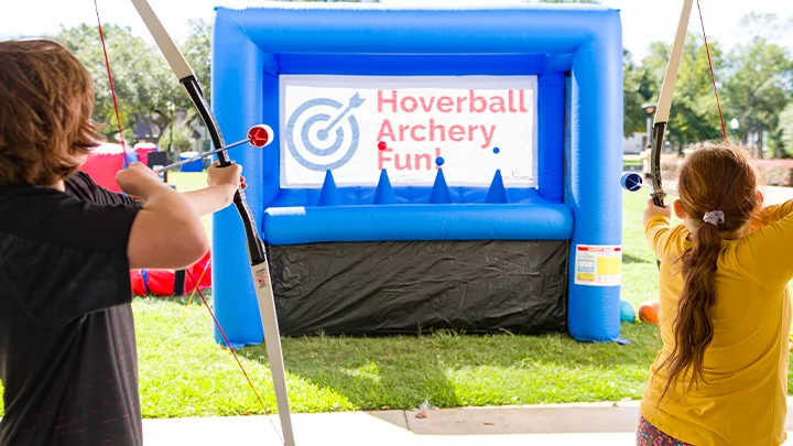 Kids shooting archery targets with our exciting carnival game.