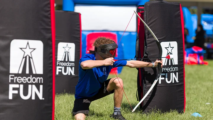 Kid using our archery tag rental for a birthday party