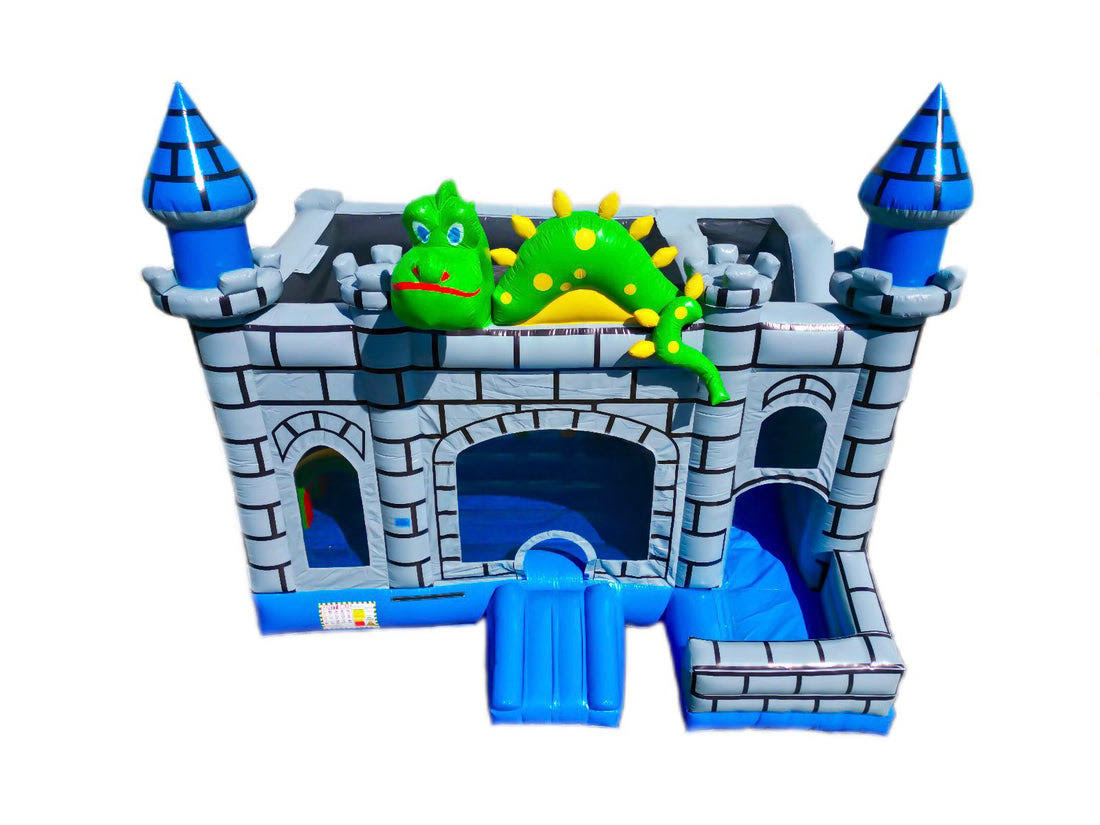 Front view of a dragon-themed inflatable bounce house and slide combo, designed like a medieval castle with blue turrets and a smiling green dragon on top, set against a white background - combo and bounce house rentals in Austin, Texas