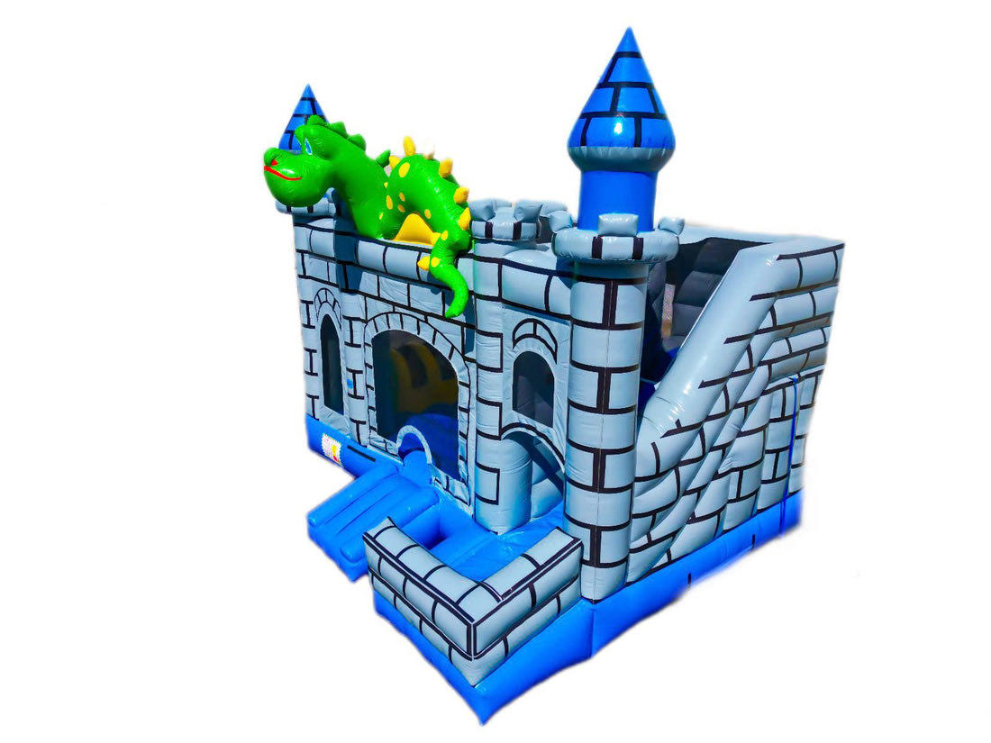 Side view of a dragon-themed inflatable bounce house combo designed as a gray castle with blue turrets, featuring a green dragon on top and dual entry ramps in the front - rent combo / bounce house in Austin, Texas