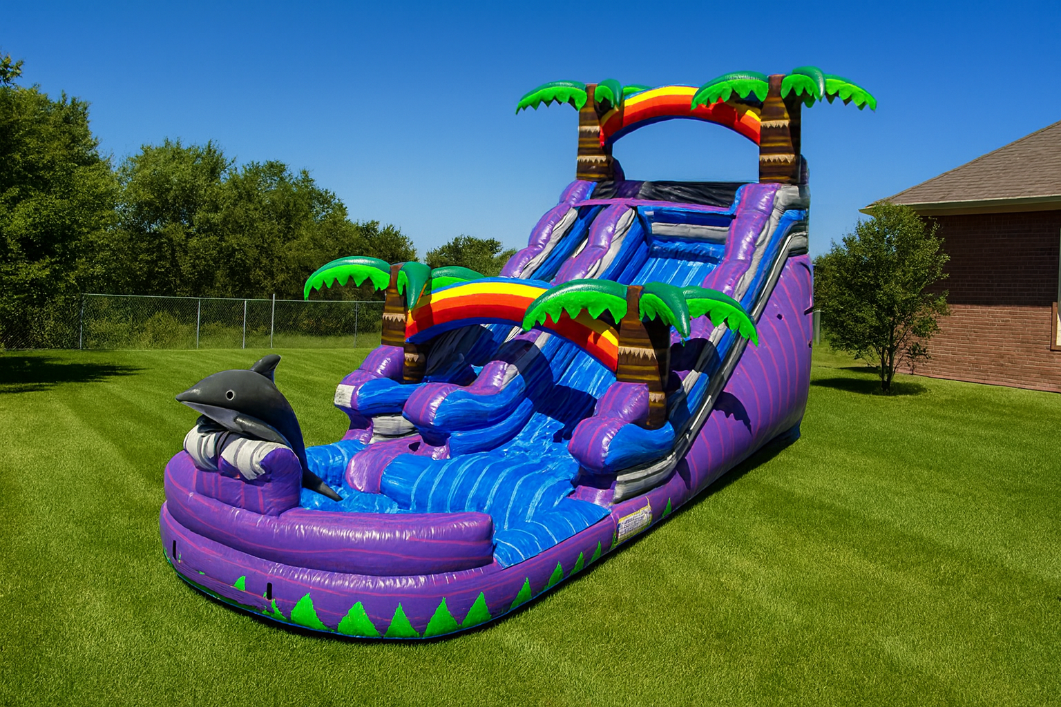A giant blue inflatable waterslide rental setup outdoors
