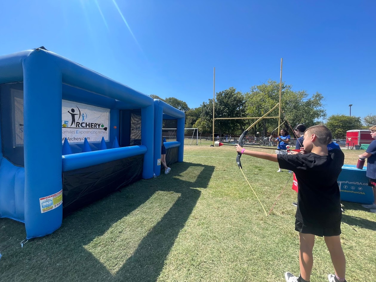 kid shooting archery at hoverball game