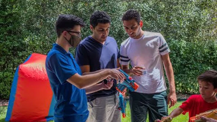 Adults getting ready for a fun mobile nerf laser tag party for their teambuilding activity. Our mobile laser tag equipment rental packages are great for team builders, birthdays, school events & more.